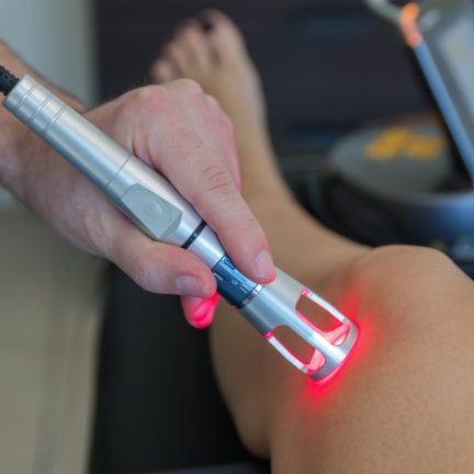 Laser therapy on a knee used to treat pain. selective focus